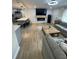 Open-concept living space seamlessly blends kitchen and living area with a stylish fireplace feature at 9153 86Th Ave, Seminole, FL 33777