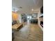 Spacious living room open to the kitchen featuring modern tile flooring, gray walls, and a fireplace at 9153 86Th Ave, Seminole, FL 33777