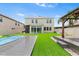 A backyard with artificial turf, a pool, and a gazebo at 14095 Tropical Kingbird Way, Riverview, FL 33579