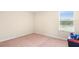 Cozy bedroom features neutral carpet, and a window bringing in lots of natural light at 14095 Tropical Kingbird Way, Riverview, FL 33579