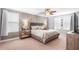 Tranquil bedroom with wood-accent wall and neutral decor at 14095 Tropical Kingbird Way, Riverview, FL 33579