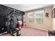 A bedroom with a personal gym, neutral colored carpet, and natural light at 14095 Tropical Kingbird Way, Riverview, FL 33579