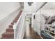 Entry hallway with hardwood floors leads to the staircase and living spaces at 14095 Tropical Kingbird Way, Riverview, FL 33579