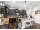 Modern kitchen with granite counters, an island with bar stools, and stainless steel appliances at 14095 Tropical Kingbird Way, Riverview, FL 33579
