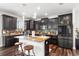 Bright kitchen with dark cabinets, granite countertops, and an island with seating at 14095 Tropical Kingbird Way, Riverview, FL 33579