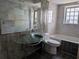 Bathroom features unique sink, marble-tiled walls, and a walk-in shower at 155 Summerset Dr, Punta Gorda, FL 33982