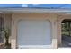 Attached two car garage in neutral color, great for parking or storage with canal views nearby at 155 Summerset Dr, Punta Gorda, FL 33982
