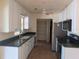 Bright kitchen with white cabinets, stainless steel appliances and a pantry for storage at 155 Summerset Dr, Punta Gorda, FL 33982