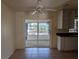 An open kitchen featuring a large sliding door, white cabinets and tiled flooring at 155 Summerset Dr, Punta Gorda, FL 33982