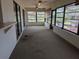 Enclosed patio with multiple windows, ceiling fans, and sliding doors offering views of the backyard at 155 Summerset Dr, Punta Gorda, FL 33982