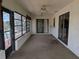 Enclosed patio with multiple windows, ceiling fans, and sliding doors leading to the backyard pool area at 155 Summerset Dr, Punta Gorda, FL 33982