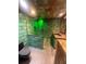 Modern bathroom with glass-enclosed shower, unique brick-style tile, and stylish vanity at 37951 Washington Loop Rd, Punta Gorda, FL 33982