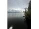 Scenic view of the lake, tall grasses, and trees under an overcast sky at 37951 Washington Loop Rd, Punta Gorda, FL 33982