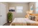 Inviting bedroom with cozy decor, a natural wood bed frame, and warm neutral tones at 4111 13Th S Ave, St Petersburg, FL 33711