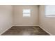 Neutral bedroom with wood-look flooring illuminated by natural light from bright windows at 4111 13Th S Ave, St Petersburg, FL 33711