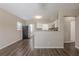 Open floor plan with dining area leading to a well-lit kitchen featuring white cabinets at 4111 13Th S Ave, St Petersburg, FL 33711