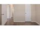 Hallway view showcasing modern wood-look floors complemented by neutral walls and white doors at 4111 13Th S Ave, St Petersburg, FL 33711