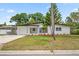 Charming single-story home featuring a lush green lawn and an attached carport at 5629 36Th N Ave, St Petersburg, FL 33710