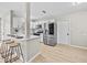 Bright kitchen with stainless steel appliances, white cabinets, and bar stool seating at 5629 36Th N Ave, St Petersburg, FL 33710