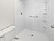 Accessible bathroom showcasing a walk-in shower, grab bar, and convenient shelving for easy use and safety at 6623 Baybrooks Cir, Temple Terrace, FL 33617