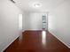 This empty bedroom features hardwood floors, neutral walls and a small, decorative window at 6623 Baybrooks Cir, Temple Terrace, FL 33617