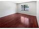 A bright bedroom features a hardwood floor and a window at 6623 Baybrooks Cir, Temple Terrace, FL 33617