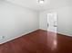 This empty bedroom features hardwood floors, neutral walls and access to an en-suite bathroom at 6623 Baybrooks Cir, Temple Terrace, FL 33617