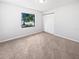 Inviting bedroom with a window and closet, featuring plush carpet and providing lots of space at 6623 Baybrooks Cir, Temple Terrace, FL 33617