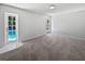 Spacious bedroom featuring carpet and pool access through glass paneled door, offering natural light and relaxing views at 6623 Baybrooks Cir, Temple Terrace, FL 33617
