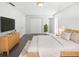 Bright bedroom featuring a light wood bed frame, plush bedding, and ample natural light at 6623 Baybrooks Cir, Temple Terrace, FL 33617