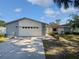 Charming single-story home featuring a spacious front yard, and an attached two car garage at 6623 Baybrooks Cir, Temple Terrace, FL 33617