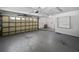 Spacious two-car garage with concrete floors, a window and a large whiteboard at 6623 Baybrooks Cir, Temple Terrace, FL 33617