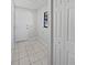 This hallway features tile flooring, a window, access to the exterior and a linen closet at 6623 Baybrooks Cir, Temple Terrace, FL 33617
