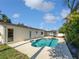 This backyard oasis features a sparkling in-ground pool surrounded by lush landscaping, creating a private retreat at 6623 Baybrooks Cir, Temple Terrace, FL 33617