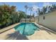 Backyard showcasing refreshing pool with palm trees, ideal for relaxation and enjoying outdoor living at 6623 Baybrooks Cir, Temple Terrace, FL 33617