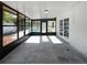 Bright sunroom with tiled floors and glass paneled view of pool, providing a perfect indoor-outdoor living space at 6623 Baybrooks Cir, Temple Terrace, FL 33617