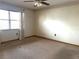 Bedroom with neutral carpet, ceiling fan, and a bright window at 129 104Th Ave # 205, Treasure Island, FL 33706
