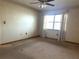 Bedroom with neutral carpet, ceiling fan, and a bright window at 129 104Th Ave # 205, Treasure Island, FL 33706