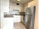 Traditional-style kitchen featuring stainless steel appliances and white cabinets at 129 104Th Ave # 205, Treasure Island, FL 33706