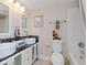 Bathroom featuring double sinks, modern fixtures, and decorative mosaic tiling at 2115 Valrico Heights Blvd, Valrico, FL 33594