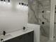 Modern bathroom features a double vanity, a walk-in shower with marble-look tile, and stylish fixtures at 267 Santa Marta St, Port Charlotte, FL 33954