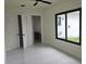Bedroom with an outside view through a large window, an ensuite bathroom, and tiled floors at 267 Santa Marta St, Port Charlotte, FL 33954