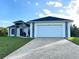 Beautiful single-story home with a well-manicured lawn and long brick driveway, enhancing curb appeal at 267 Santa Marta St, Port Charlotte, FL 33954