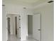 Hallway boasts white doors and tile flooring, providing access to different areas of the home at 267 Santa Marta St, Port Charlotte, FL 33954