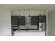 Modern kitchen featuring gray cabinetry, stainless steel appliances, and a large island with a marble countertop at 267 Santa Marta St, Port Charlotte, FL 33954