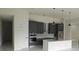 Contemporary kitchen with gray cabinets, stainless appliances, and pendant lights over a white marble island at 267 Santa Marta St, Port Charlotte, FL 33954