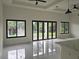Bright living area featuring large windows and glass doors opening to scenic outdoor views and high ceilings at 267 Santa Marta St, Port Charlotte, FL 33954