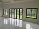 Spacious living room with large glass doors and windows that bring in the natural outdoor views at 267 Santa Marta St, Port Charlotte, FL 33954