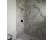 Modern shower with rainfall shower head featuring marble-look tile surround and dark hardware at 267 Santa Marta St, Port Charlotte, FL 33954