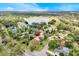 Aerial view of the property showcasing its location near a lake and surrounded by trees at 2900 Hammock Dr, Plant City, FL 33566